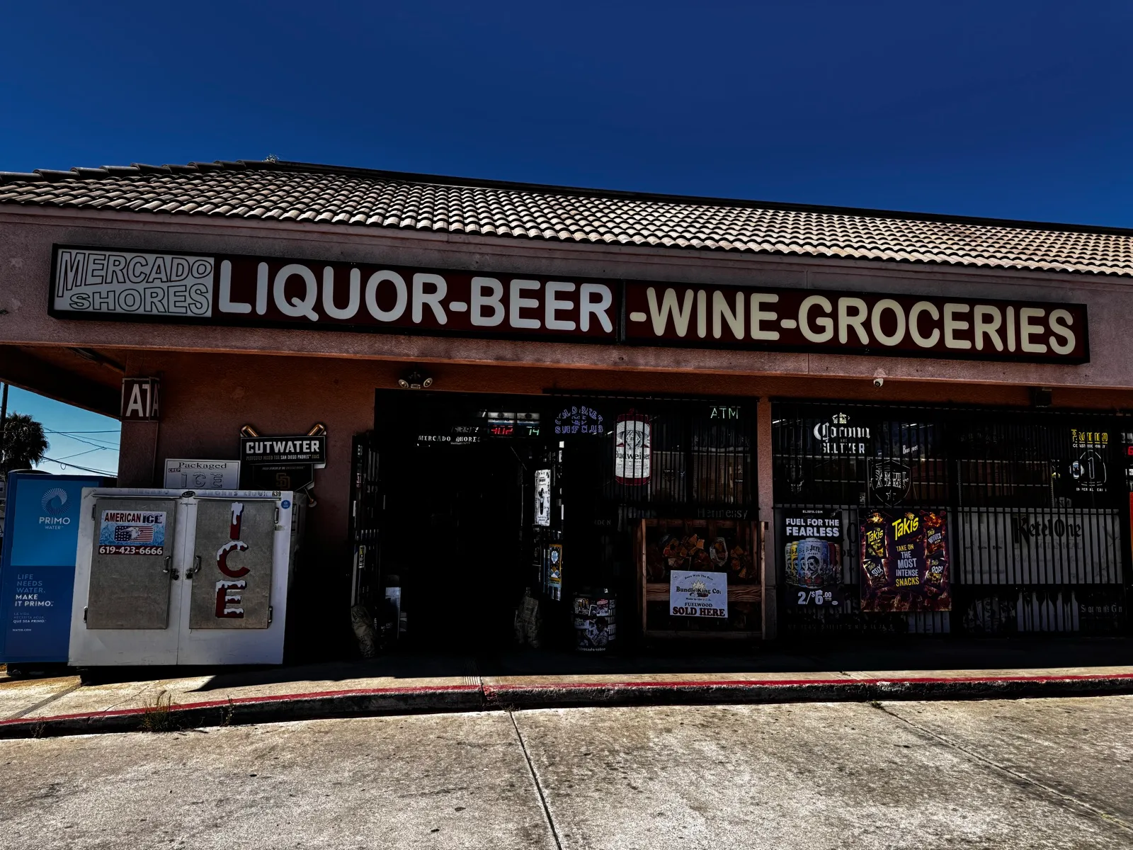 Mercado Shores storefront on 7th Street — Liquor, Beer, Wine, Groceries sign